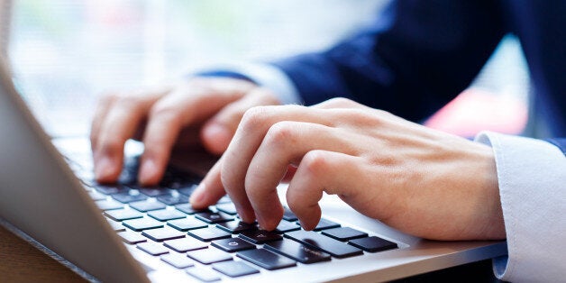 close up view of businessman typing on laptop indoors