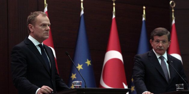 Turkey's Prime Minister Ahmet Davutoglu, right, and European Council President Donald Tusk speak to the media during a joint press conference in Ankara, Turkey, Thursday, March 3, 2016. Tusk says it is up to Turkey to decide what further measures it can take to reduce the flow of migrants but says many in Europe favor a mechanism that would allow the âfast and large-scaleâ shipment of migrants back to Turkey and such a mechanism would âeffectively break the business model of the smugglers.(AP Photo/Burhan Ozbilici)