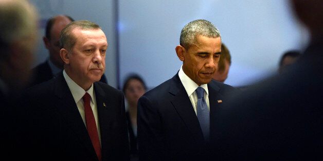 U.S President Barack Obama, right, and Turkeyâs President Recep Tayyip Erdogan during a moment of silence for those who died in Friday's attacks in Paris, at the start of a working session of the G-20 Summit in Antalya, Turkey, Sunday, Nov. 15, 2015. Obama is attending the G-20 Summit while on a nine-day foreign trip that also includes stops in the Philippines and Malaysia for other global security and economic summits. (AP Photo/Susan Walsh)