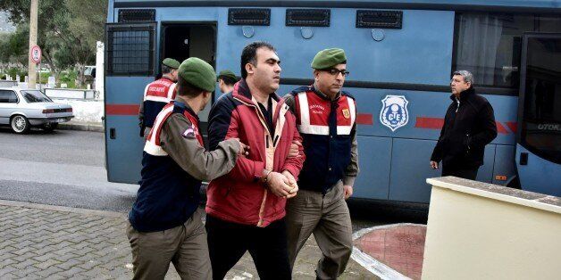 MUGLA, TURKEY - FEBRUARY 11: Turkish gendarmeries escort 2 Syrians, arrested on suspicion of causing deaths of 5 refugees including Aylan Kurdi,as they brought to the court in Mugla, Turkey on February 11, 2016. Aylan Kurdi,3 year old kid drowned after boat sank on route to the Greek islands in the Aegean Sea. (Photo by Ali Balli/Anadolu Agency/Getty Images)