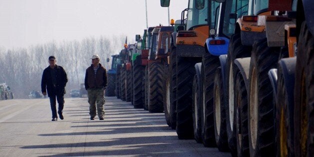 KASTANIES, GREECE - FEBRUARY 01: A group of farmers block the road to Ormenio border gate with their tractors during a protest against government's amendment plans on social security act and additional taxes, on January 01, 2016 in Kastanies, Greece. (Photo by Salih Baran/Anadolu Agency/Getty Images)