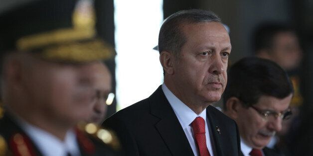 Turkish President Recep Tayyip Erdogan stands at the mausoleum of Turkey's founder Mustafa Kemal Ataturk on Victory Day in Ankara, Turkey, Sunday, Aug. 30, 2015. Turkish army's 93-year-old victory over Greece was considered crucial in Turkish Independence War and the foundation of modern Turkish republic. (AP Photo/Burhan Ozbilici)