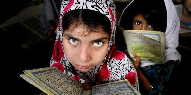 Girls read the Quran, Islam's holy book, at a local madrassa (seminary) in Karachi, Pakistan, on Wednesday, Jan. 27, 2016. (AP Photo/Fareed Khan)