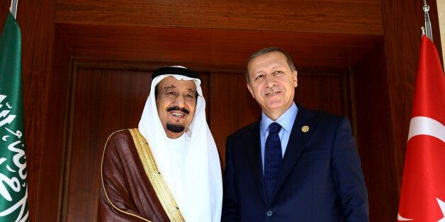 FILE - In this Saturday, Nov. 14, 2015 file photo, Turkish President Recep Tayyip Erdogan right, shakes hands with Saudi King Salman bin Abdul Aziz Al Saud, left, prior to their meeting in Antalya, Turkey ahead of the upcoming G-20 summit. Erdogan is headed to Saudi Arabia where he will meet King Salman for talks focused on the civil war in Syria. Turkey and Saudi Arabia are strong backers of the Syrian Sunni opposition fighting to oust the Iranian-backed Syrian President Bashar Assad from power. (Yasin Bulbul /Turkish Presidency Press Office /Anadolu Agency via AP, Pool, File)