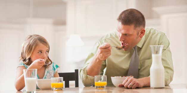 USA, Utah, Lehi, Father and daughter (6-7) eating breakfast