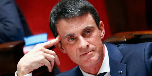 French Prime Minister Manuel Valls reacts to speeches in the lower house of Parliament in Paris, France, Friday, Feb. 5, 2016. French Prime Minister Manuel Valls is appealing to legislators to approve a divisive bill, prompted by last year's attacks on Paris, that would revoke the citizenship of convicted terrorists with dual nationality. (AP Photo/Francois Mori)