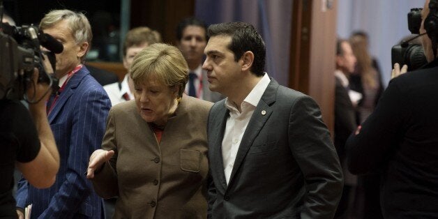 German Chancellor Angela Merkel (L) speaks with Greek Prime Minister Alexis Tsipras (R) before the final European Union (EU) summit of the year at the European Council in Brussels on December 18, 2015. / AFP / JOHN THYS (Photo credit should read JOHN THYS/AFP/Getty Images)