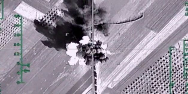 In this photo made from the footage taken from Russian Defense Ministry official web site on Monday, Feb. 1, 2016, an aerial image shows what it says is a column of heavy trucks carrying ammunition hit by a Russian air strike near Aleppo, Syria. The Russian military has beefed up its air group in Syria with state-of-the art fighter jets amid tensions with Turkey. (Russian Defense Ministry Press Service photo via AP)