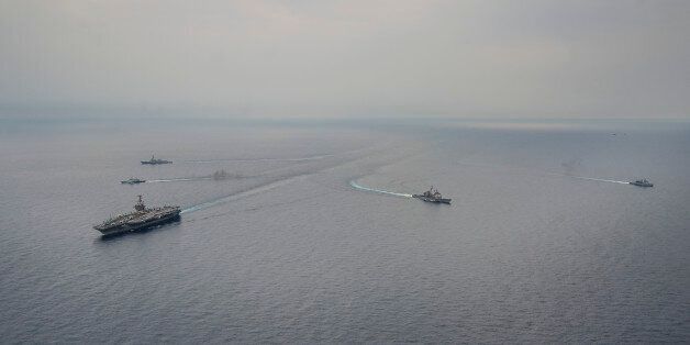 SOUTH CHINA SEA (June 24, 2014) Ships from the George Washington Carrier Strike Group (GWCSG) and Royal Malaysian Navy steam in formation during a photo exercise. The GWCSG is on patrol in the 7th Fleet area of operations supporting security and stability in the Indo-Asia-Pacific region. (U.S. Navy photo by Mass Communication Specialist 1st Class Trevor Welsh/Released)