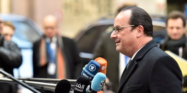 French President Francois Hollande speaks to the media as he arrives for an EU summit at the EU Council building in Brussels on Friday, Feb. 19, 2016. European Union leaders are holding a summit in Brussels on Thursday and Friday to hammer out a deal designed to keep Britain in the 28-nation bloc. (AP Photo/Martin Meissner)