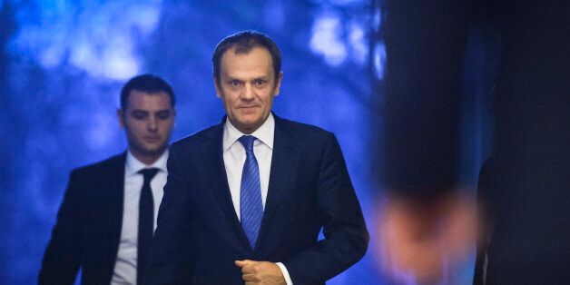 European Council President Donald Tusk, center, approaches Romanian President Klaus Iohannis, right, after arriving at the Cotroceni presidential palace in Bucharest, Romania, Monday, Feb. 15, 2016. Tusk visited Romania on Monday and warned of a possible European Union break-up after discussing the issue of the UK leaving the EU, a prospect known as