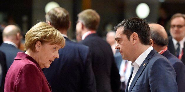 German Chancellor Angela Merkel, left, talks with Greek Prime Minister Alexis Tsipras, right, during the EU summit in Brussels, Belgium on Thursday, Oct. 15, 2015. European Union heads of state meet to discuss, among other issues, the current migration crisis. (AP Photo/Martin Meissner)