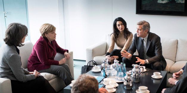 BERLIN, GERMANY - FEBRUARY 12: In this handout photo provided by the German Government Press Office (BPA) Chancellor Angela Merkel (2nd L) meets with George Clooney and Amal Clooney (2nd R) at the Federal Chancellery to talk about refugee policy and Germany's commitment to the International Rescue Committee, on February 12, 2016 in Berlin, Germany. (Photo by Guido Bergmann/Bundesregierung via Getty Images)
