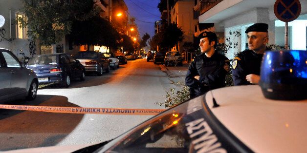 Greek police investigate after anti-terrorist police arrested four men and detained several other suspects after discovering a large weapons cache on December 4, 2010 in an Athens suburb. The arrests, which include a suspected bank robber, were carried out following a police raid on a garage in the district of Nea Smyrni, a few kilometres (miles) from Athens, and in other homes in the capital. AFP PHOTO/STR (Photo credit should read STR/AFP/Getty Images)