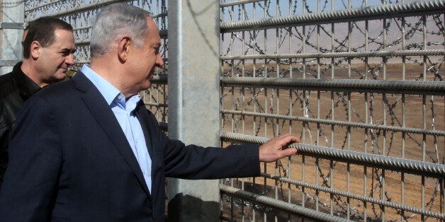 Israeli Prime Minister Benjamin Netanyahu visits the construction site of a new military border fence between Israel and Jordan, on February 9, 2016. Israel has begun construction on a security fence along its border with Jordan, the defence ministry announced, its latest such barrier intended to keep out illegal migrants and militants. The barrier will be 30 kilometres (19 miles) long between the resort city of Eilat and the site of the Sands of Samar and will cost 300 million shekels ($75 mill