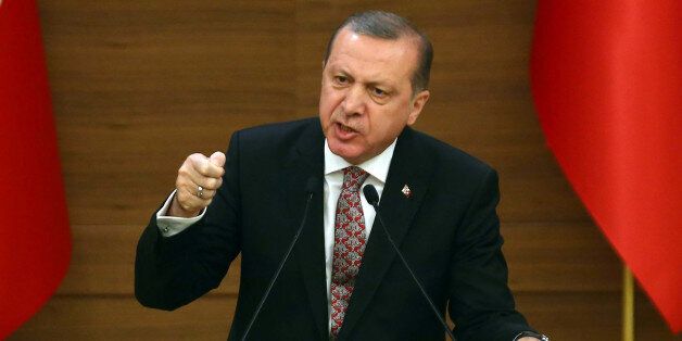 Turkey's President Recep Tayyip Erdogan (C) attends the monthly Mukhtars meeting (local administrators) at the Presidential Complex in Ankara on February 10, 2016.Turkish President Recep Tayyip Erdogan on February 10 accused the United States of creating a 'pool of blood' in the region by failing to recognise the main Syrian Kurdish organisations as terror groups. / AFP / ADEM ALTAN (Photo credit should read ADEM ALTAN/AFP/Getty Images)