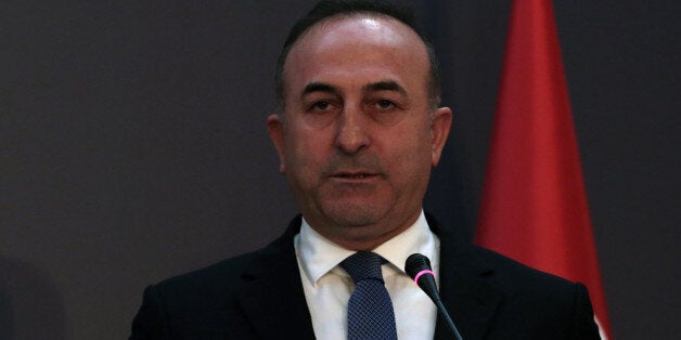 Turkish Foreign Minister Mevlut Cavusoglu speaks during a press conference with European Union's Foreign Policy Chief Federica Mogherini and EU Commissioner for Enlargement Johannes Hahn in Ankara, Turkey, Monday, Jan. 25, 2016. Cavusoglu has said the Syrian Kurdish forces' participation in U.N-led peace talks for Syria in Geneva would be