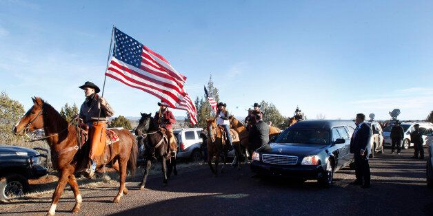 KANAB, UT - FEBRUARY 5: People line the road as a horse honor guard escorts the hurst after the funeral of rancher Robert 'LaVoy' Finicum on February 5, 2016 in Kanab, Utah. Finicum who was part of the Burns, Oregon standoff with federal officials was shot and killed by FBI agents when they tried to detain him at a traffic stop on February 27, 2016. ( Photo by George Frey/Getty Images