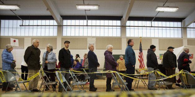 Voters wait in line to cast ballots at a polling station inside Broken Gound Elementary School in Concord, New Hampshire, U.S., on Tuesday, Feb. 9, 2016. Voters in New Hampshire took to the polls today in the nation's first primary in the U.S. presidential race. Photographer: Victor J. Blue/Bloomberg via Getty Images