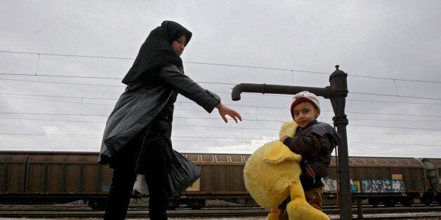 A refugee boy, carrying a giant stuffed duck, tries to catch up with his mother while both walk towards the border with Serbia from the transit center for refugees near northern Macedonian village of Tabanovce, Wednesday, Feb. 10, 2016. Macedonian authorities are reinforcing a barrier at the country's border with Greece that is designed to limit the number of migrants and refugees crossing into the country, accepting people only from war-affected zones who declare Austria or Germany as their fin