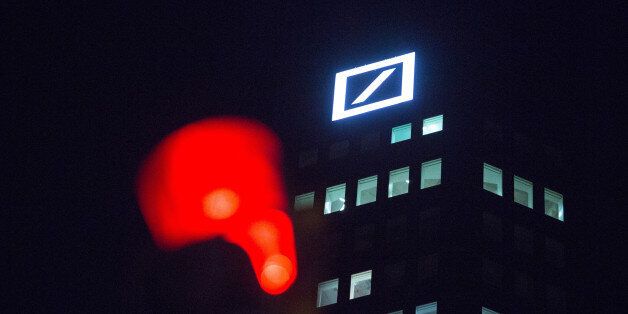The Deutsche Bank AG, logo sits illuminated on the bank's headquarter offices at night in Frankfurt, Germany, on Wednesday, Jan. 27, 2016. German domestic demand, buoyed by a stable labor market and low oil prices, will propel the country's economic growth this year and compensate for slowing exports as emerging economies stumbles. Photographer: Krisztian Bocsi/Bloomberg via Getty Images