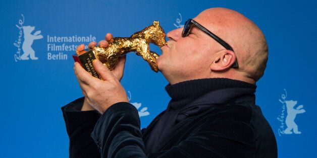Italian director Gianfranco Rosi kisses his Golden Bear trophy for Best Film for the film 'Fuocoammare (Fire at Sea)' during a photocall at the awards ceremony of the 66th Berlinale, Europe's first major film festival of the year, on February 20, 2016 in Berlin. / AFP / POOL / Bernd Von Jutrczenka (Photo credit should read BERND VON JUTRCZENKA/AFP/Getty Images)
