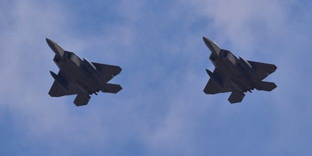 US F-22 stealth fighters fly over Osan Air Base in Pyeongtaek, south of Seoul, on February 17, 2016. The radar-evading aircraft flew across South Korea on February 17 to an air base near Seoul where they are being deployed in a show of force following Pyongyang's nuclear and missile tests. AFP PHOTO / JUNG YEON-JE / AFP / JUNG YEON-JE (Photo credit should read JUNG YEON-JE/AFP/Getty Images)