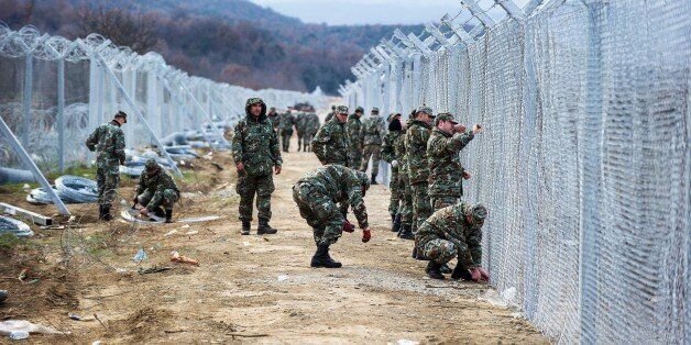 Macedonian soldiers build a second border fence to prevent illegal crossings by migrants at the Greek-Macedonian border near Gevgelija on February 8, 2016.Macedonia started on February 8, 2016 erecting double razor fence,digging holes, erecting pillars, erecting razor fence and is extending fence on new places along side by Greek border line. / AFP / Robert ATANASOVSKI (Photo credit should read ROBERT ATANASOVSKI/AFP/Getty Images)