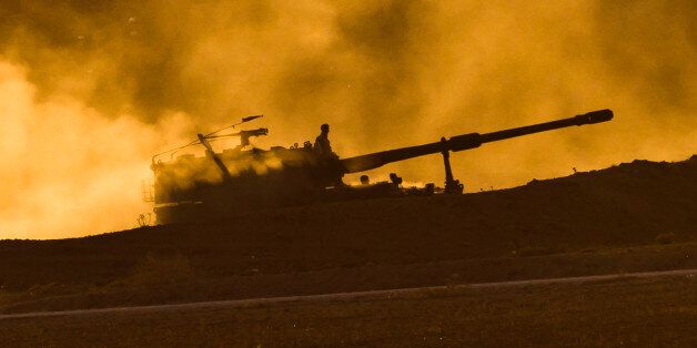 A Turkish military mobile artillery unit drives at sunset on a hill overlooking the Syrian city of Kobani, outside Suruc, on the Turkey-Syria border Tuesday, Nov.11, 2014. Kobani, also known as Ayn Arab, and its surrounding areas, has been under assault by extremists of the Islamic State group since mid-September and is being defended by Kurdish fighters. (AP Photo/Vadim Ghirda)