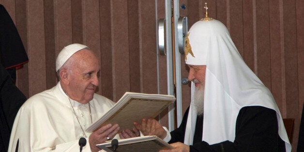 Pope Francis, left, and Russian Orthodox Patriarch Kirill exchange documents during their historic meeting in Havana, Cuba, Friday, Feb. 12, 2016. Francis and Kirill signed a joint declaration on religious unity. The declaration calls for peace in Syria, Iraq and Ukraine and urges Europe to