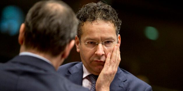 Dutch Finance Minister Jeroen Dijsselbloem, right, speaks with a member of his delegation during a meeting of EU finance ministers at the EU Council building in Brussels on Tuesday, Dec. 8, 2015. EU finance ministers are set to debate in Brussels ways to better track financial transfers, control pre-pay bank cards, freeze assets and limit movements of cash and precious metals. (AP Photo/Virginia Mayo)