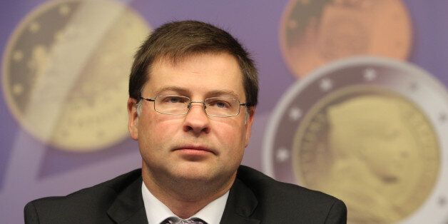 Latvian Prime Minister Valdis Dombrovskis addresses the media on the adoption of the euro, at the European Council building in Brussels, Tuesday, July 9, 2013. European finance ministers are welcoming Latvia's upcoming adoption of the euro currency as a bright spot of progress amid the wider economic gloom. (AP Photo/Yves Logghe)