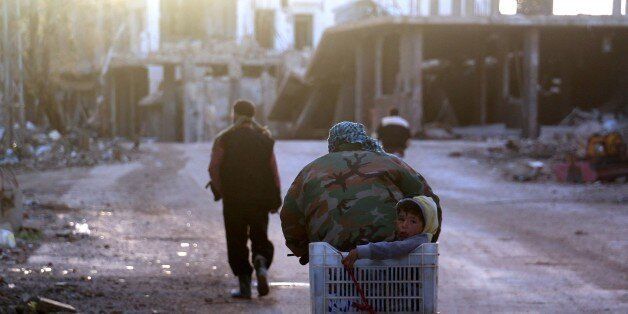 DAMASCUS, SYRIA - JANUARY 28: Syrians leave the territory because of the clashes between Syrian opponents and Assad Regime forces at Darayya town in Damascus, Syria on January 28, 2016. (Photo by Mejd al-Ahmed/Anadolu Agency/Getty Images)