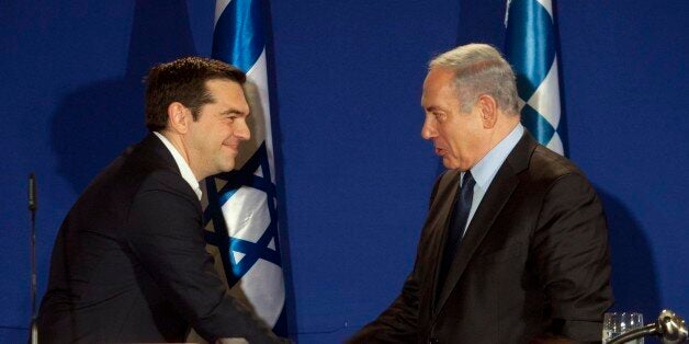 Greek Prime Minister Alexis Tsipras, right, and Israeli prime minister Benjamin Netanyahu shake hands after signing agreements strengthening bilateral relations in Jerusalem. Wednesday, Jan. 27, 2016. (Dan Balilty/AP Photo)