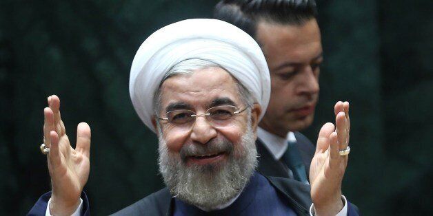 Iranian President Hassan Rouhani salutes before addressing a Turkish-Iranian bussines forum in Ankara on June 10, 2014. Rouhani said the sanctions hit country would try to secure a deal in negotiations with world powers on its long-running nuclear dispute. 'Iran will do its best for a final deal with the P5 plus 1,' made up of the five permanent UN Security Council members Britain, China, France, Russia and the United States, plus Germany, Rouhani told a business forum in Ankara through translat