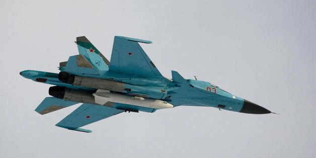 A Su-34 bomber jet with Russian President Dmitry Medvedev aboard flies over the Kubinka airfield near Moscow in Kubinka on March 28, 2009. The white object under the jet is an external fuel tank. AFP PHOTO / POOL / ALEXANDER ZEMLIANICHENKO (Photo credit should read ALEXANDER ZEMLIANICHENKO/AFP/Getty Images)