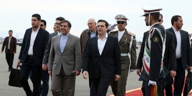 Greek Prime Minister, Alexis Tsipras, center, is welcomed by Iranian Transport Minister Abbas Akhoundi, center left, as he arrives at Mehrabad Airport, Tehran, Iran, Sunday, Feb. 7, 2016. (AP Photo/Vahid Salemi)