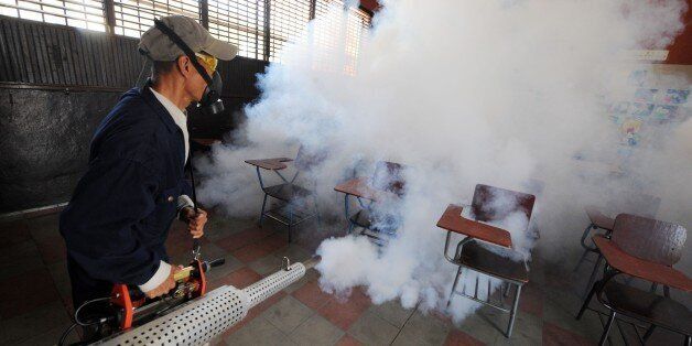 Health ministry personnel fumigate against the Aedes aegypti mosquito, vector of the dengue, Chikungunya and Zika viruses in Tegucigalpa, , on February 1, 2016. Honduran President Juan Orlando Hernandez on Friday declared the country on a preventive state of alert due to the Zika virus which in the last 44 days killed a person and infected some 1000. AFP PHOTO/Orlando SIERRA. / AFP / ORLANDO SIERRA (Photo credit should read ORLANDO SIERRA/AFP/Getty Images)