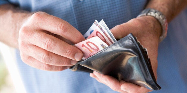 Man counting banknotes in wallet