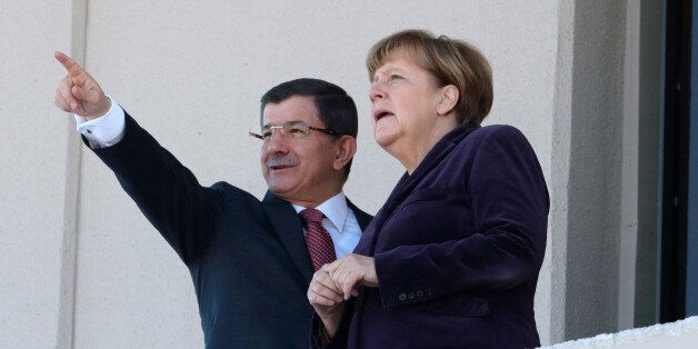 German Chancellor Angela Merkel, right, and Turkish Prime Minister Ahmet Davutoglu speak as they look towards the city center after a welcome ceremony in Ankara, Turkey, Monday, Feb. 8, 2016. Merkel is meeting Davutoglu and other Turkish officials for talks on reducing the influx of migrants to Europe. Turkey, a key country on the migrant route to Europe, is central to Merkel's diplomatic efforts to reduce the flow. (AP Photo/Burhan Ozbilici)