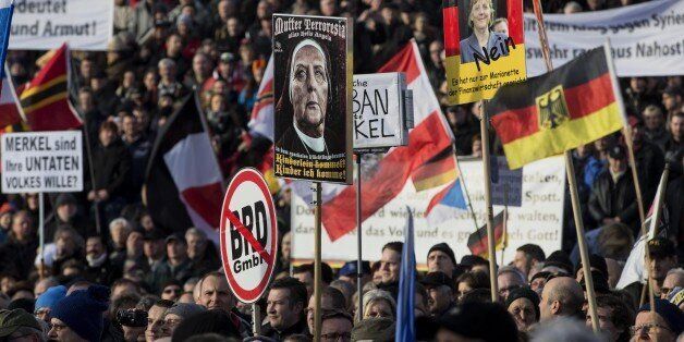 DRESDEN, GERMANY - FEBRUARY 6: Supporters of Pegida (Patriotic Europeans against the Islamization of the West) hold banners during a demonstration called 'Patriotic's day' at Konigsufer square in Dresden, Germany on February 6, 2016. (Photo by Mehmet Kaman/Anadolu Agency/Getty Images)