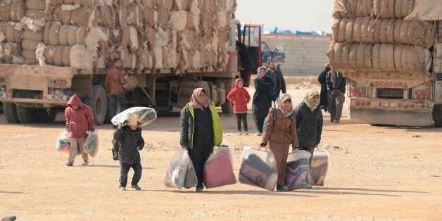 ALEPPO, SYRIA - FEBRUARY 5: Syrians are seen at Es-Selam Border Gate on Turkey's border in Azez district of Aleppo as they flee to Turkey to escape heavy Syrian regime and Russian airstrikes, on February 5, 2016. (Photo by Mustafa Sultan/Anadolu Agency/Getty Images)