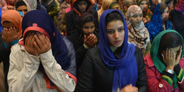 Pakistani women pray for Bacha Khan University victims at a sports complex in Islamabad on January 21, 2016. Pakistan observed a day of national mourning on January 21 for 21 people killed when heavily armed gunmen stormed a university in the troubled northwest, exposing the failings in a national crackdown on extremism. AFP PHOTO / Farooq NAEEM / AFP / FAROOQ NAEEM (Photo credit should read FAROOQ NAEEM/AFP/Getty Images)