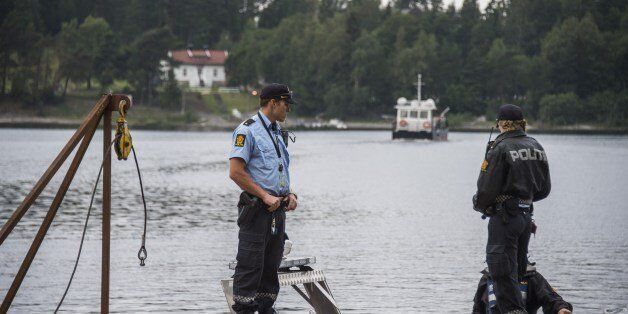 Police officers guard the waterfront point as M/S Thorbjorn ferry brings activists from the Norwegian Labour Party Youth division ( AUF ) to the Utoya island some 40 km west of Oslo on August 7, 2015, where they hold their first summer camp session since the 2011 bloodbath.On July 22, 2011 far-right extremist Anders Behring Breivik massacred 69 people during an AUF camp on the island. AFP PHOTO / ODD ANDERSEN (Photo credit should read ODD ANDERSEN/AFP/Getty Images)