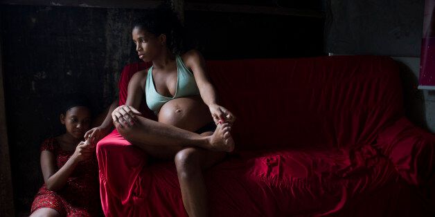In this Jan. 29, 2016 photo, Tainara Lourenco, who is five months pregnant, sits inside her house at a slum in Recife, Brazil. Like many of the estimated 400,000 women currently pregnant in Brazil, she canât afford mosquito repellent. The government has pledged to start providing repellent to low-income women and promises to deploy the Armed Forces to help eliminate Aedesâ breeding places. (AP Photo/Felipe Dana)
