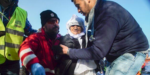 Volunteers help an elderly woman from Afghanistan to disembark from a dinghy after her arrival with other migrants and refugees in the village of Skala Sykaminias, on the northeastern Greek island of Lesbos on Wednesday, Jan. 27, 2016. Greek authorities say a total of seven bodies, including those of two children, have been recovered from the sea off the eastern Aegean island of Kos after a boat carrying migrants or refugees sank early Wednesday. (AP Photo/Mstyslav Chernov)