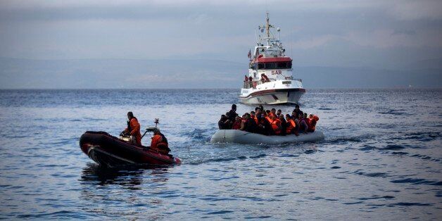 Officers of the European Union border security agency, Frontex, pull a dinghy with migrants to Skala Sikaminias village on the northeastern Greek island of Lesbos, Wednesday, Oct. 21, 2015. Greece is the main entry point for those fleeing violence at home and seeking a better life in the European Union. More than 500,000 people have arrived so far this year on Greece's eastern islands, paying smugglers to ferry them across from nearby Turkey. (AP Photo/Santi Palacios)