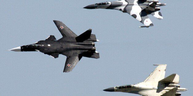 Russian fighter aircrafts Su-47 (L) and two SU-27 fly in formation during the MAKS-2005 international air show in Zhukovsky near Moscow August 18, 2005. Some 520 Russian and 134 foreign companies presented their products at the air show, Itar-Tass news agency reported. REUTERS/Viktor Korotayev