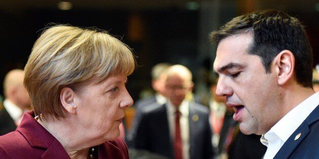 German Chancellor Angela Merkel (L) speaks with Greek Prime Minister Alexis Tsipras before a round table, during a European Union (EU) summit dominated by the migration crisis at the European Council in Brussels, on October 15, 2015. AFP PHOTO/ ALAIN JOCARD (Photo credit should read ALAIN JOCARD/AFP/Getty Images)