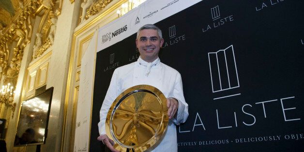 French Swiss Chef Benoit Violier of the restaurant Hotel de Ville in Crissier, Switzerland, poses with his trophy for the best restaurant of the World during the award ceremony of